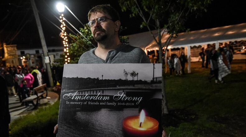 AMSTERDAM, NY - Oct. 8: Mourners attend a candlelight vigil for the victims of the fatal limousine crash in Amsterdam, N.Y. Twenty people died in Saturday's crash in Schoharie, N.Y. about 25 miles south of Amsterdam. The dead included the driver of the limo, 17 passengers and two pedestrians. (Photo by Stephanie Keith/Getty Images)