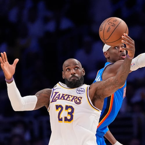 Los Angeles Lakers forward LeBron James, left, takes a pass as Oklahoma City Thunder guard Shai Gilgeous-Alexander defends during the first half of Game 3 in a second-round NBA basketball playoffs series Saturday, May 9, 2026, in Los Angeles. (AP Photo/Mark J. Terrill)