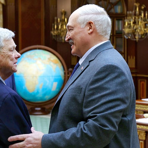 In this photo released by Belarusian presidential press service, Belarusian President Alexander Lukashenko, right, and U.S. Presidential envoy John Coale shake hands during their meeting in Minsk, Belarus, Friday, Dec. 12, 2025. (Belarusian Presidential Press Service via AP)