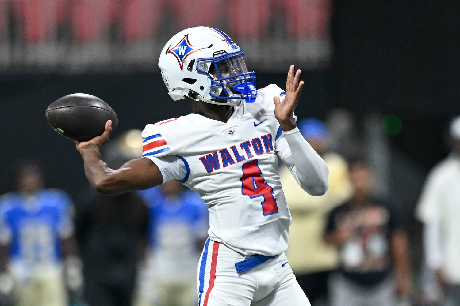 Walton quarterback Christion Peacock (4) drops back for a pass during the first half of the Corky Kell Classic football game Saturday, August 16, 2025 at the Mercedes-Benz Stadium. (Daniel Varnado/For the Atlanta Journal-Constitution)