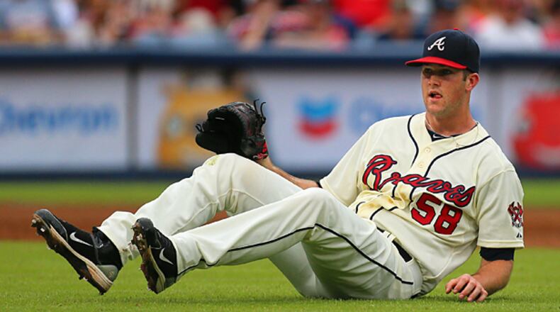 090113 Atlanta: - DOWN AND OUT -- Braves pitcher Alex Wood hits the ground on a ground ball by Marlins Giancarlo Stanton to short stop Andrelton Simmons during the second inning in their MLB baseball game on Sunday, Sept. 1, 2013, in Atlanta. Woods was pulled in the third inning trailing the Marlins 7-0.