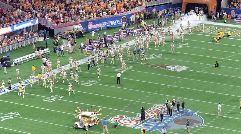 GA Tech's Ramblin Wreck and cheerleaders lead the football on the field before NCAA college football game against the Tennessee at the Mercedes-Benz Stadium on Monday, September 4, 2017. HYOSUB SHIN / HSHIN@AJC.COM