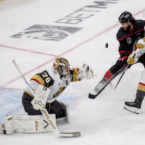 Vegas Golden Knights' Carter Hart (79) knocks a puck away from the net as Golden Knights' Jack Eichel (9) and Carolina Hurricanes' Jalen Chatfield (5) battle during the second period of Game 2 of the NHL hockey Stanley Cup Final series in Raleigh, N.C., Thursday, June 4, 2026. (AP Photo/Ben McKeown)