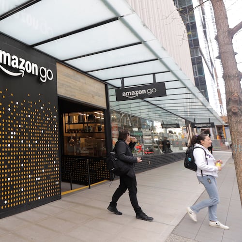 FILE - People walk out of an Amazon Go store in Seattle, March 4, 2020. (AP Photo/Ted S. Warren, File)