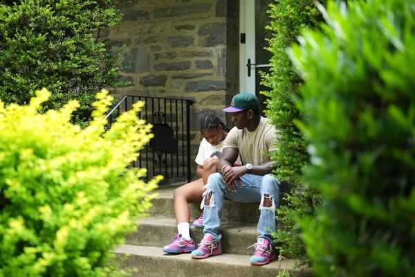 Evan Polk, right, talks with his daughter, Jordyn Polk, 13, after she was dropped off from school in Secane, Pa., Thursday, June 5, 2025. (AP Photo/Matt Slocum)