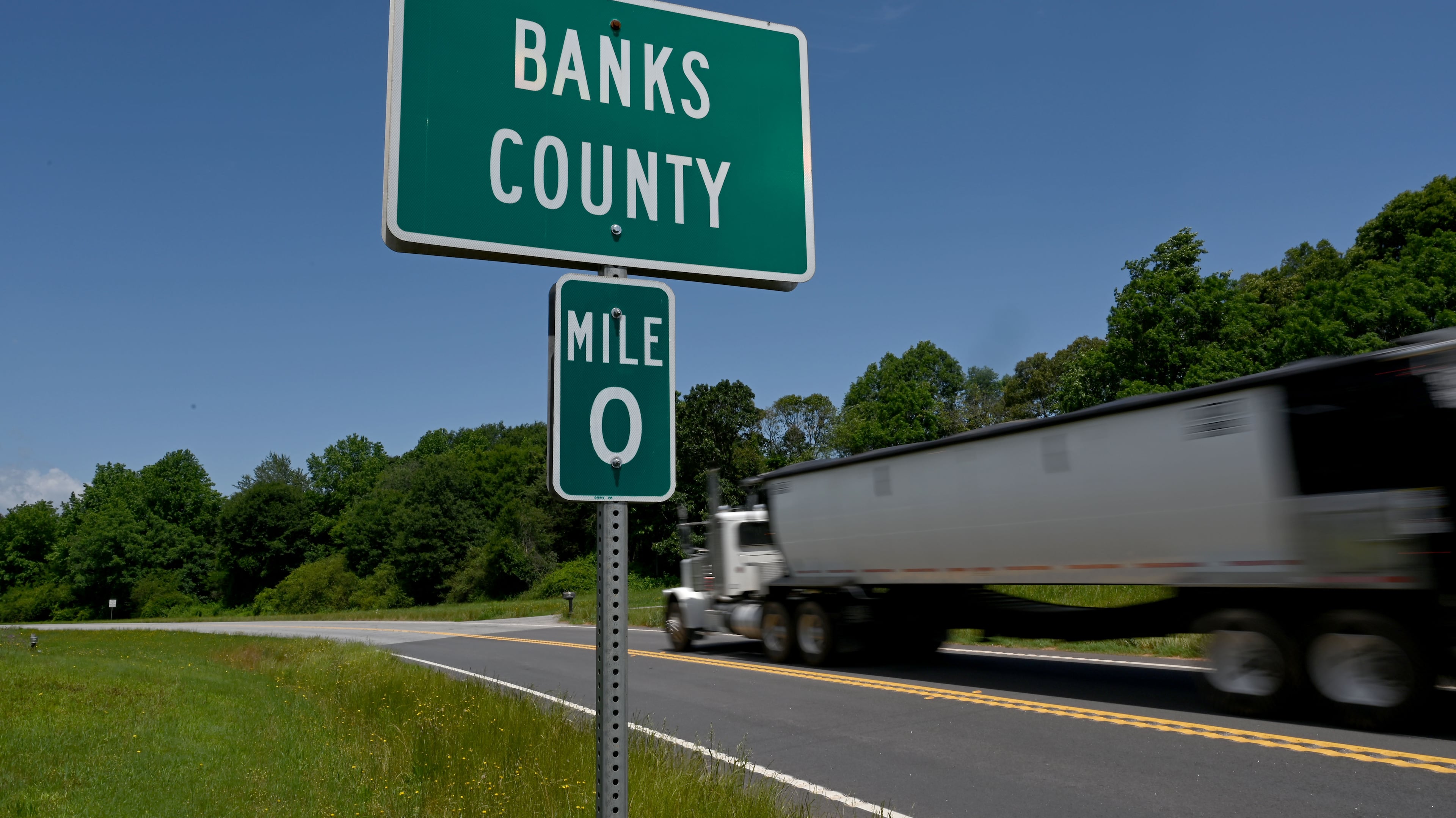 Banks County 0 mile sign is displayed on Old Federal Road, Wednesday, May 21, 2025, in Carnesville. The boundary between Banks and Franklin mysteriously moved to the east, allowing the Banks sheriff to claim he lives in the county and keep his job as the top lawman. (Hyosub Shin / AJC)