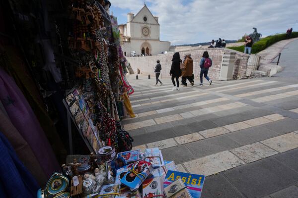 Souvenirs of Carlo Acutis, the 15-year-old Italian boy who died in 2006 of leukemia and beatified in 2020, are displayed in a shop in Assisi, Italy, Wednesday, April 2, 2025. (AP Photo/Alessandra Tarantino)