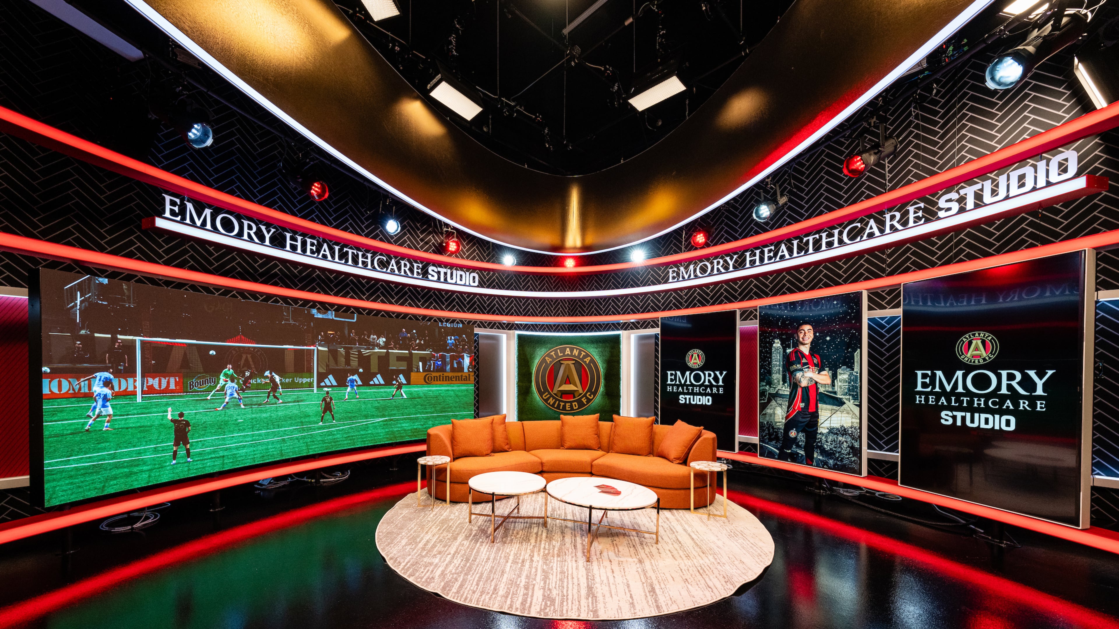 The video studio at the expanded Children’s Healthcare of Atlanta Training Ground in Marietta contains a large, curved LED screen and smaller LED panels that can display different content in the background while hosts and guests talk on a large couch. (Mitch Martin/Atlanta United)