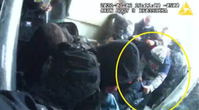 In a still photo captured from police body cameras, a man investigators say is Douglas County resident Phillip Marion "Bunky" Crawford Jr. is seen grabbing a fallen police officer during fighting on Jan. 6, 2021, at the U.S. Capitol.