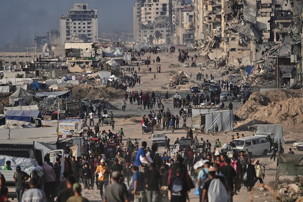 Displaced Palestinians walk past the ruins of destroyed buildings along the Gaza City shoreline on Monday, June 9, 2025. (AP Photo/Jehad Alshrafi)