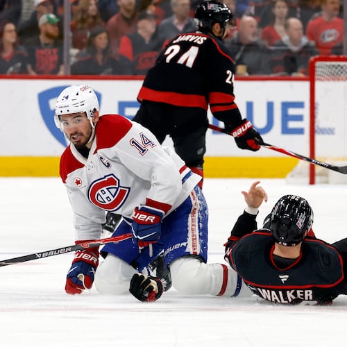 Montréal Canadiens' Nick Suzuki (14) collides with Carolina Hurricanes' Seth Jarvis (24) resulting in both getting penalties during the first period in Game 1 of the Eastern Conference finals NHL hockey Stanley Cup playoffs series in Raleigh, N.C., Thursday, May 21, 2026. (AP Photo/Karl DeBlaker)