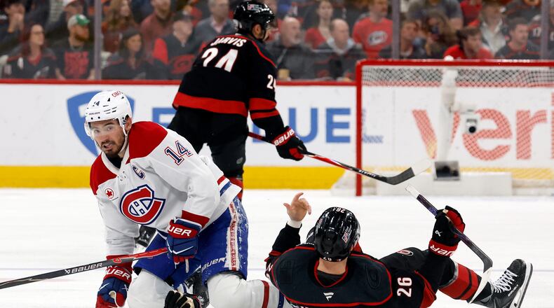 Montréal Canadiens' Nick Suzuki (14) collides with Carolina Hurricanes' Seth Jarvis (24) resulting in both getting penalties during the first period in Game 1 of the Eastern Conference finals NHL hockey Stanley Cup playoffs series in Raleigh, N.C., Thursday, May 21, 2026. (AP Photo/Karl DeBlaker)