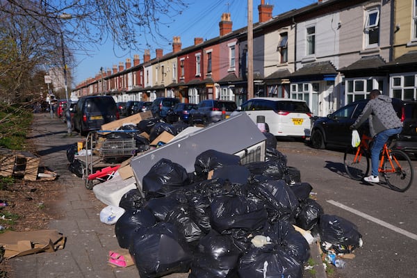 Rubbish piles up on a residential street in Birmingham, England, Monday, April 7, 2025, amid an ongoing refuse workers' strike in the city. (AP Photo/Kirsty Wigglesworth)