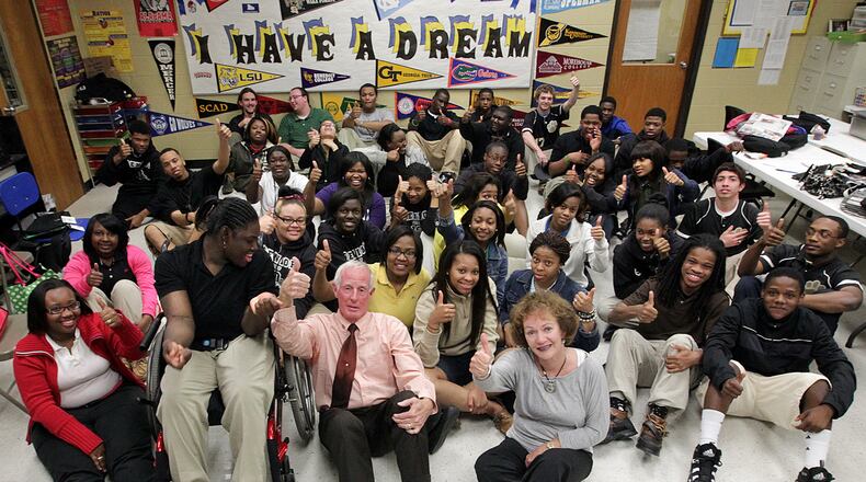 Thumbs up: Tom and Kathy Kelly with the Dreamers at Greene County High School in March 2012. In 2000 the couple promised a class of kindergartners they would send them to college if the children graduated from high school. Now many of those same kids are graduating from college. (AJC file / Curtis Compton)
