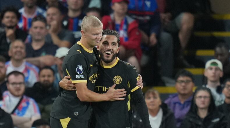 Manchester City's Rayan Cherki, right, celebrates with Erling Haaland after scoring his side's third goal during the English Premier League soccer match between Crystal Palace and Manchester City in London, Friday, Aug. 28, 2026. (AP Photo/Kin Cheung)