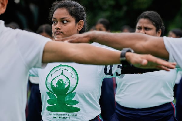 People perform yoga on International Yoga Day at Victoria Memorial compound, in Kolkata, India, Saturday, June 21, 2025. (AP Photo/Bikas Das)