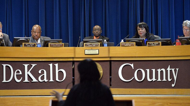 DeKalb County commissioners (from left) Jeff Rader, Stan Watson, Larry Johnson, Sharon Barnes Sutton and Kathie Gannon listen during a public comment session at a meeting at Dekalb County Government Administration Building in Decatur on Tuesday, Aug. 26, 2014.