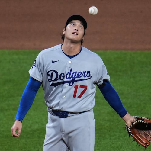 Los Angeles Dodgers two-way player Shohei Ohtani waits to hand the ball to manager Dave Roberts, after giving up a two-run double to Pittsburgh Pirates' Brandon Lowe during the seventh inning of a baseball game in Pittsburgh, Wednesday, June 10, 2026. (AP Photo/Gene J. Puskar)
