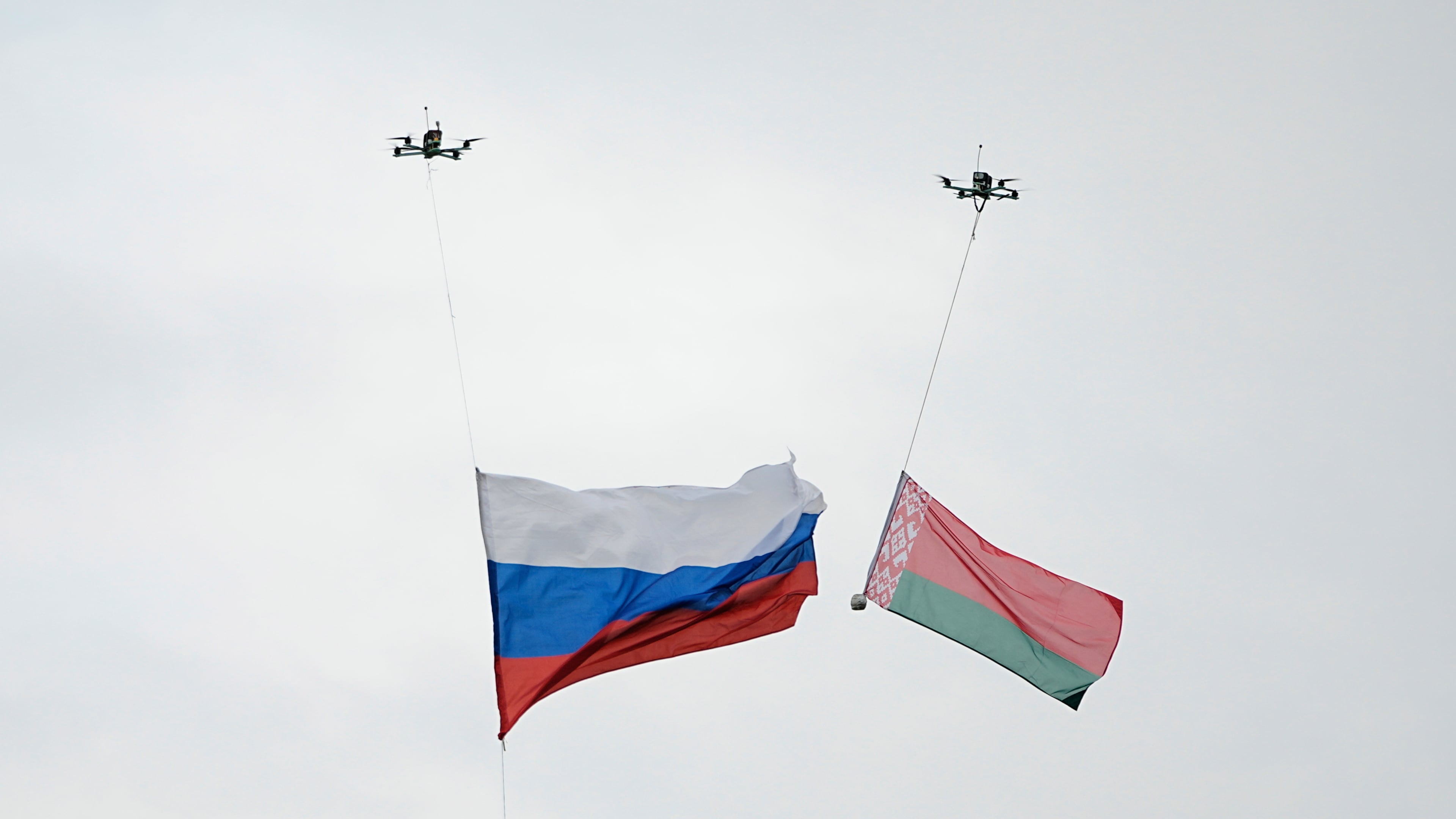Drones each carry a Russia, left, and Belarus national flag, during the joint Russian-Belarusian military drills at a training ground near Barysaw, Belarus, Monday, Sept. 15, 2025. (AP Photo/Pavel Bednyakov)