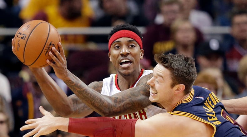 Atlanta Hawks’ Jeff Teague (0) passes around Cleveland Cavaliers’ Matthew Dellavedova (8), from Australia, in the first half of an NBA basketball game Saturday, Nov. 21, 2015, in Cleveland. (AP Photo/Tony Dejak)