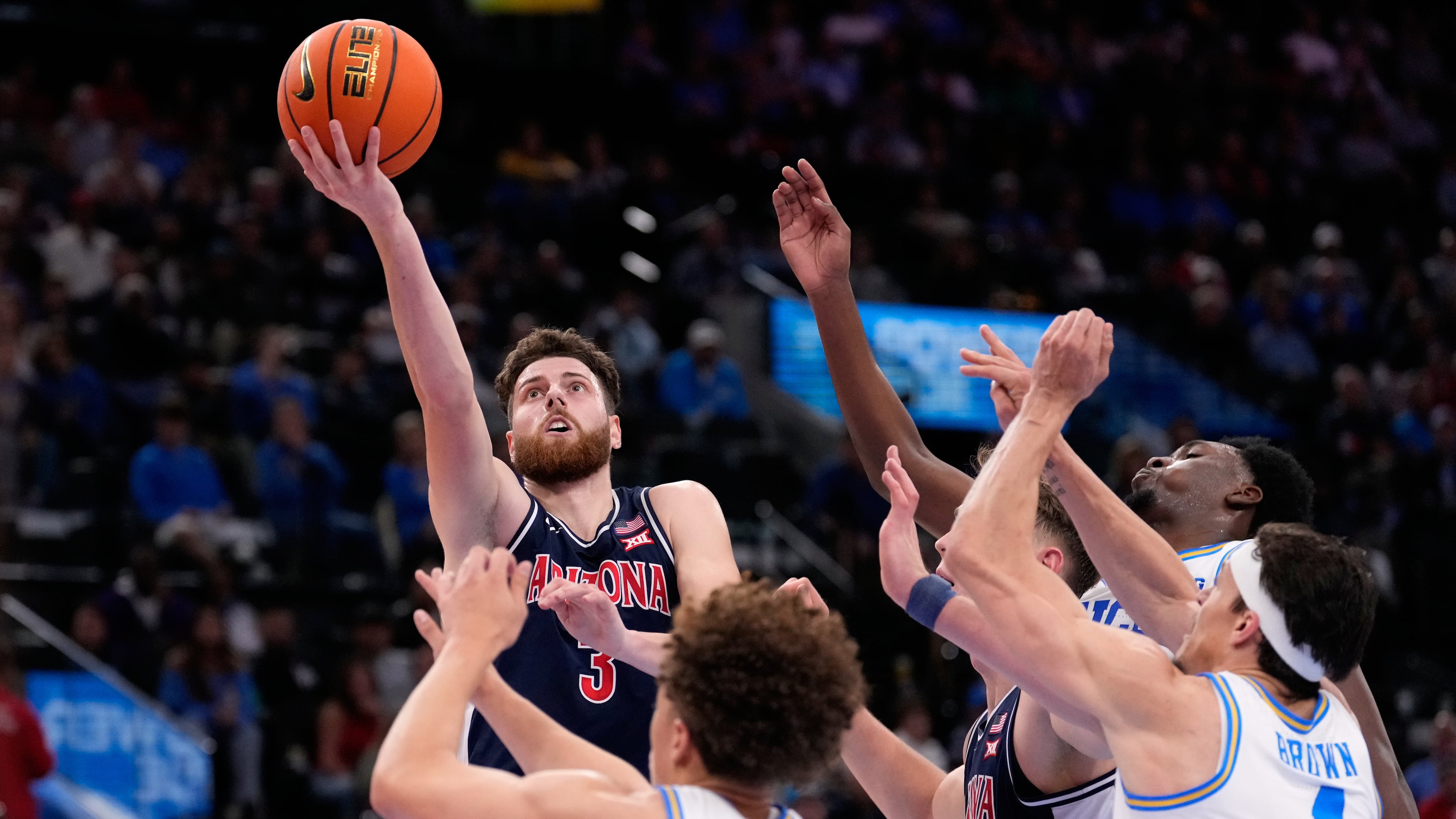 Arizona guard Anthony Dell'Orso (3) shoots as UCLA guard Trent Perry (0) defends during the first half of a Hall of Fame Series college basketball game Friday, Nov. 14, 2025, in Inglewood, Calif. (AP Photo/Mark J. Terrill)