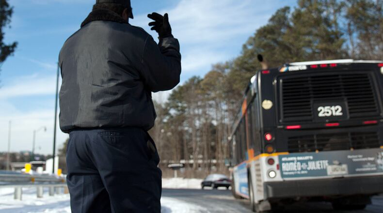 Marta Employee Tony Wright directs another Marta driver off of the Ashford Dunwoody exit on Interstate 285 Wednesday, Jan. 29, 2014 in Dunwoody, Ga.