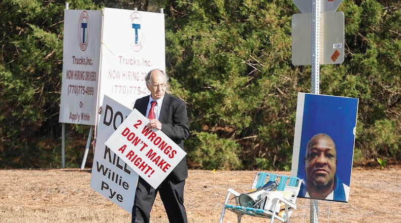 Attorney Daniel Kolber holds signs that read ‚"Don't Kill Willie Pye" and "Two Wrongs Don't Make a right", across from Georgia Diagnostic Prison in Jackson, Ga. where Willie James Pye, was executed on Wednesday, March 20, 2024. (Natrice Miller/ Natrice.miller@ajc.com)