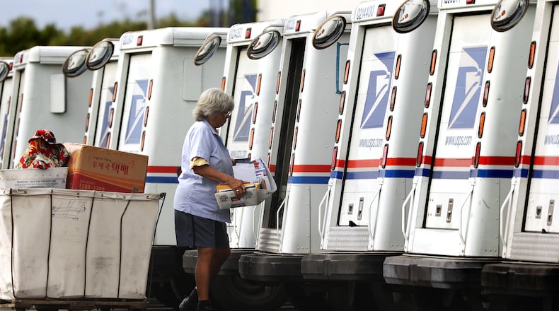 A mail carrier loads a truck for delivery at a United States post office. (TNS)