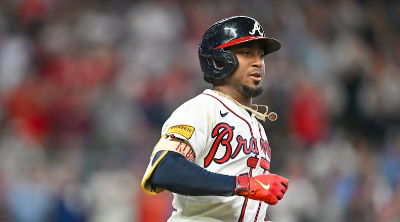 Atlanta Braves’ Ozzie Albies (1) singles against the Philadelphia Phillies before Ronald Acuna Jr. (13) scored on an error during the sixth inning of NLDS Game 2 in Atlanta on Monday, Oct. 9, 2023.   (Hyosub Shin / Hyosub.Shin@ajc.com)