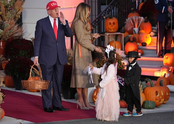 President Donald Trump and first lady Melania Trump handed candy to children dressed as the tooth fairy and Abraham Lincoln during a Halloween event at the White House on Thursday.