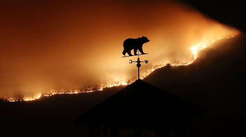 November 21, 2016, Clayton: At first glance the weathervane on the top of a barn appears to be a bear fleeing the Rock Mountain Fire as it burns across the top of ridge pole above Betty‰Û(TM)s Creek Road where home owners are under a pre-evacuation order as the fire approaches the area on Monday night, Nov. 21, 2016, just north of Clayton. Curtis Compton/ccompton@ajc.com