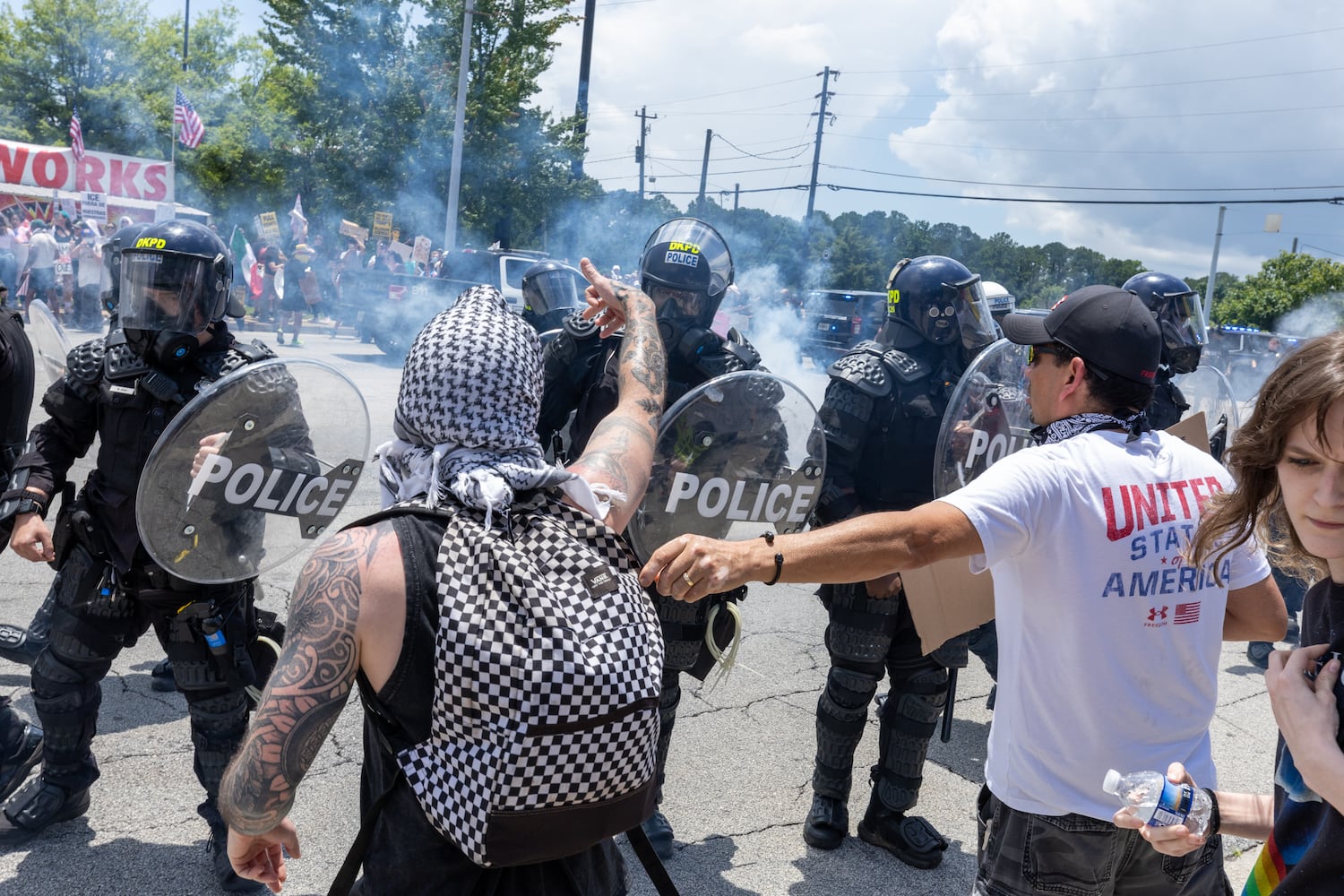 Police advance on demonstrators during a protest on ICE raids and deportation arrests on Chamblee Tucker Road in Atlanta on Saturday, June 14, 2025. (Arvin Temkar / AJC)