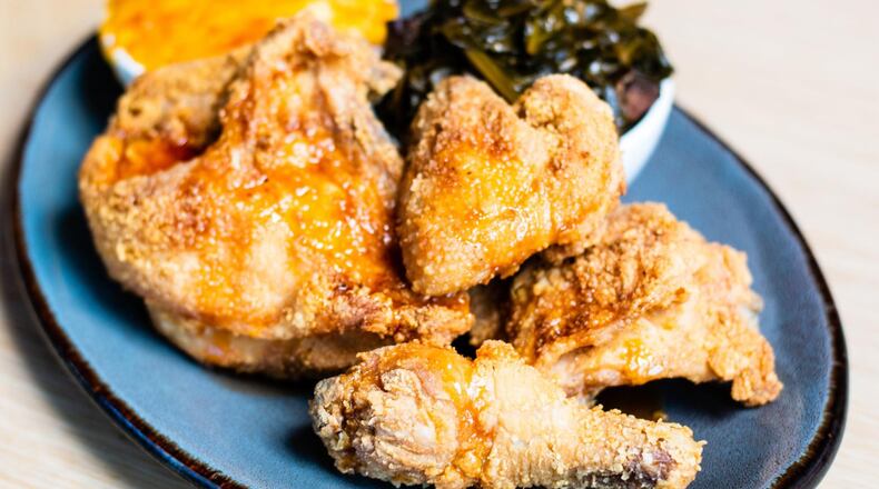 The fried chicken at Molly B’s in Mercedes-Benz Stadium is accompanied by collard greens and macaroni and cheese. CONTRIBUTED BY HENRI HOLLIS