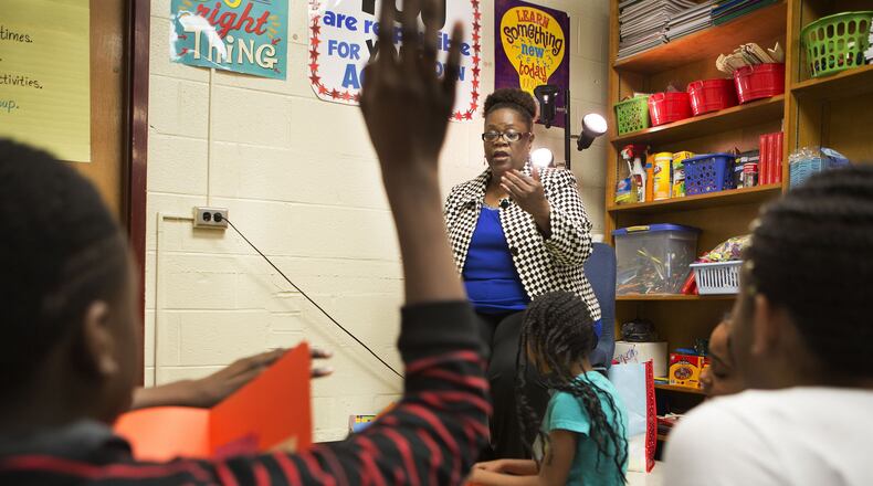 School counselor Tina Johnson meets with a small group of fifth graders that help mentor other students at Flat Shoals Elementary School in south DeKalb County Dec. 8, 2016. (Photo by Phil Skinner)