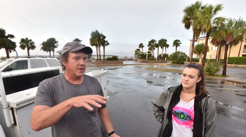 October 8, 2016 St. Simons Island - Timothy Seavey, of St. Simons Island, talks as his daughter Emily looks near St. Simons Island Pier on Saturday morning, October 8, 2016. Hurricane Matthew knocked out power, sent trees crashing down on houses and over roads and flooded parking lots and yards across St. Simons Island. Frederica Road near the air strip is covered with fallen trees. HYOSUB SHIN / HSHIN@AJC.COM