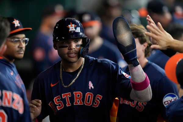 Houston Astros' Cam Smith celebrates after scoring off of a sacrifice fly by Christian Walker during the fourth inning of a baseball game against the Cincinnati Reds in Houston, Sunday, May 11, 2025. (AP Photo/Ashley Landis)