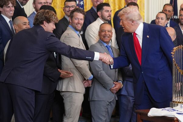 President Donald Trump, right, greets Los Angeles Dodgers' Kiké Hernández during a ceremony to honor the Major League Baseball 2024 World Series Champion Los Angeles Dodgers in the East Room of the White House, Monday, April 7, 2025, in Washington. (AP Photo/Evan Vucci)