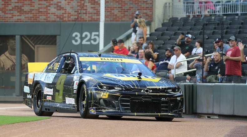 NASCAR driver Chase Elliott takes a lap around Truist Park's field before the Braves played the Nationals in an MLB game on Sept. 7, 2021, in Atlanta. (Curtis Compton / Curtis.Compton@ajc.com)