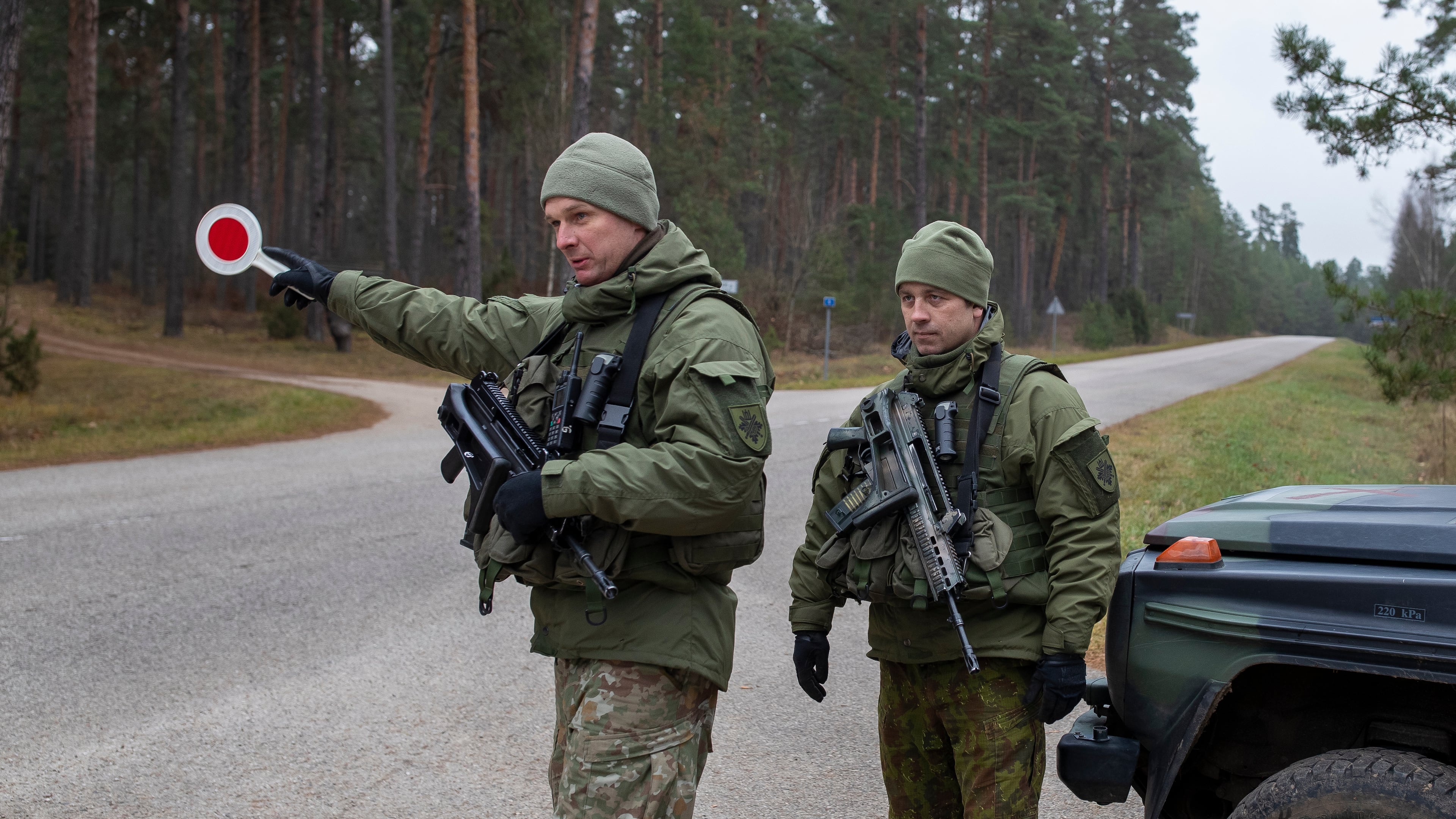 FILE - Lithuanian soldiers patrol a road near the Lithuania-Belarus border near the village of Jaskonys, Druskininkai district some 160 km (100 miles) south of the capital Vilnius, Lithuania, on Nov. 13, 2021. (AP Photo/Mindaugas Kulbis, File)
