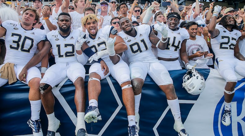 The Georgia Tech Yellow Jackets celebrate following the game against the South Florida Bulls at Bobby Dodd Stadium. Tech won 14-10. (Alyssa Pointer/alyssa.pointer@ajc.com)