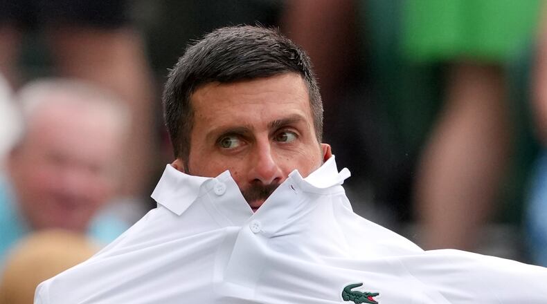 Novak Djokovic of Serbia changes his shirt during the men's singles match against Yibing Wu of China at the Wimbledon Tennis Championships in London, Monday, June 29, 2026.(AP Photo/Kin Cheung)