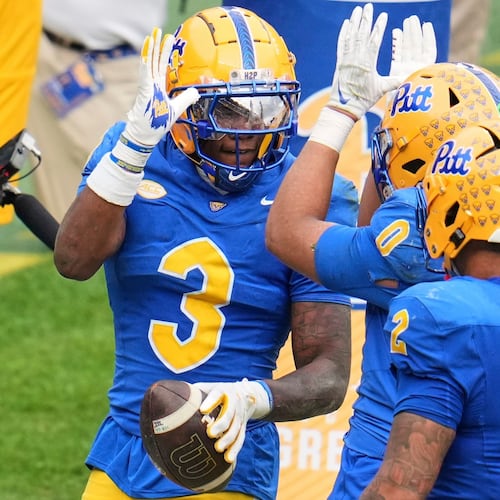 Pittsburgh linebacker Rasheem Biles (3) celebrates with linebacker Braylan Lovelace (0) after returning an interception for a touchdown during the second half of an NCAA college football game against Notre Dame in Pittsburgh, Saturday, Nov. 15, 2025. (AP Photo/Gene J. Puskar)