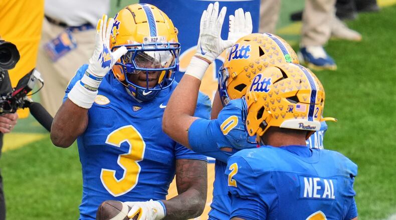 Pittsburgh linebacker Rasheem Biles (3) celebrates with linebacker Braylan Lovelace (0) after returning an interception for a touchdown during the second half of an NCAA college football game against Notre Dame in Pittsburgh, Saturday, Nov. 15, 2025. (AP Photo/Gene J. Puskar)
