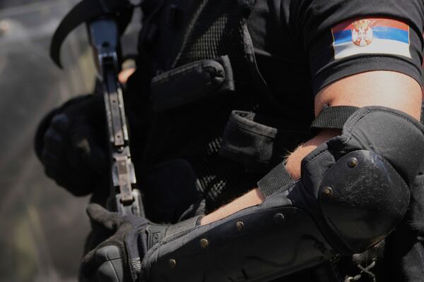 Serbian gendarmerie officers prepare to remove a street blockade that was set up as part of a protest over a spate of arrests of anti-government protesters after a massive rally demanding an early parliamentary election in Belgrade, Serbia, Monday, June 30, 2025. (AP Photo/Darko Vojinovic)