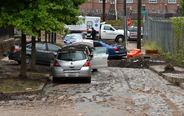 Damaged cars are shown stuck in the mud after storms dropped nearly four inches of rain near the Clark Atlanta University campus on Friday, Sept. 15, 2023. (Hyosub Shin/AJC)