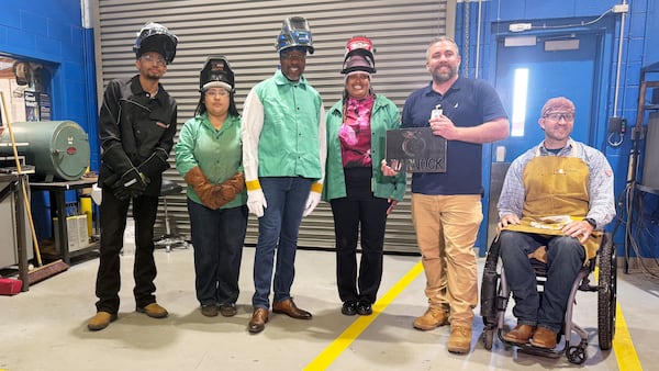 U.S. Sen. Raphael Warnock poses with students and faculty at Columbus Technical College on July 6, 2026. (Greg Bluestein/AJC)