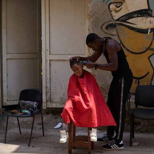 A barber cuts a boy's hair at his makeshift barbershop on the street in Havana, Wednesday, April 22, 2026. (AP Photo/Ramon Espinosa)