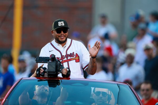 Braves legend Andruw Jones waves to fans Thursday at Truist Park as the team honored his induction into the National Baseball Hall of Fame. (Jason Getz/AJC)