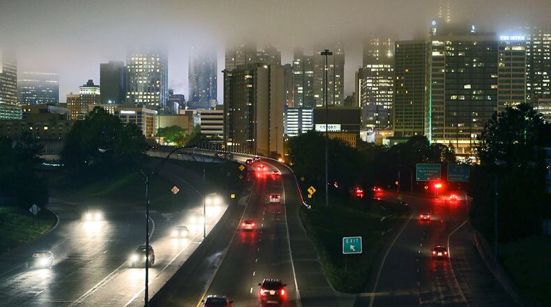 The Atlanta skyline sits in the clouds during a break in the rain April 1. Today's forecast looks a lot like this. BOB ANDRES / BANDRES@AJC.COM