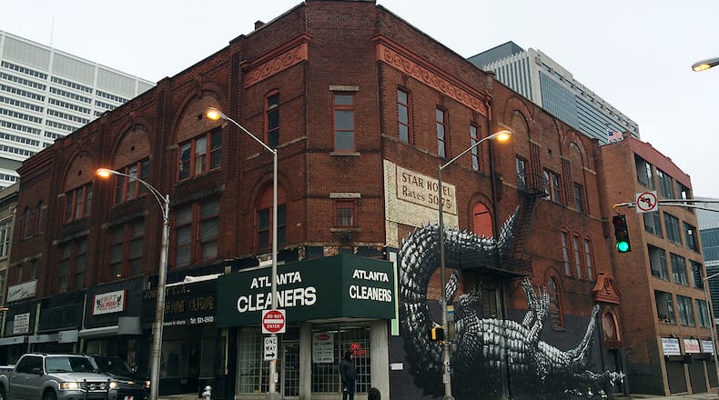 CONCORDIA HALL (201 Mitchell Street SW). Significance: One of six remaining buildings on historic Hotel Row, with a high Victorian facade, originally built for the Concordia Association, a 19th century Jewish cultural heritage organization. Read more here. The alligator mural on its side was painted in 2011 for the Living Walls arts festival, by the Belgian artist ROA. (PETE CORSON / pcorson@ajc.com)